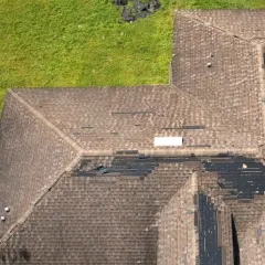 Uszkodzony dach z widocznymi ubytkami papy. Takie miejsca wskazują, jak sprawdzić gdzie przecieka dach.