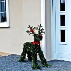 Renifer z choinki jak zrobić? Świąteczna ozdoba przed domem, wykonana z gałązek iglaków, z czerwonymi akcentami.